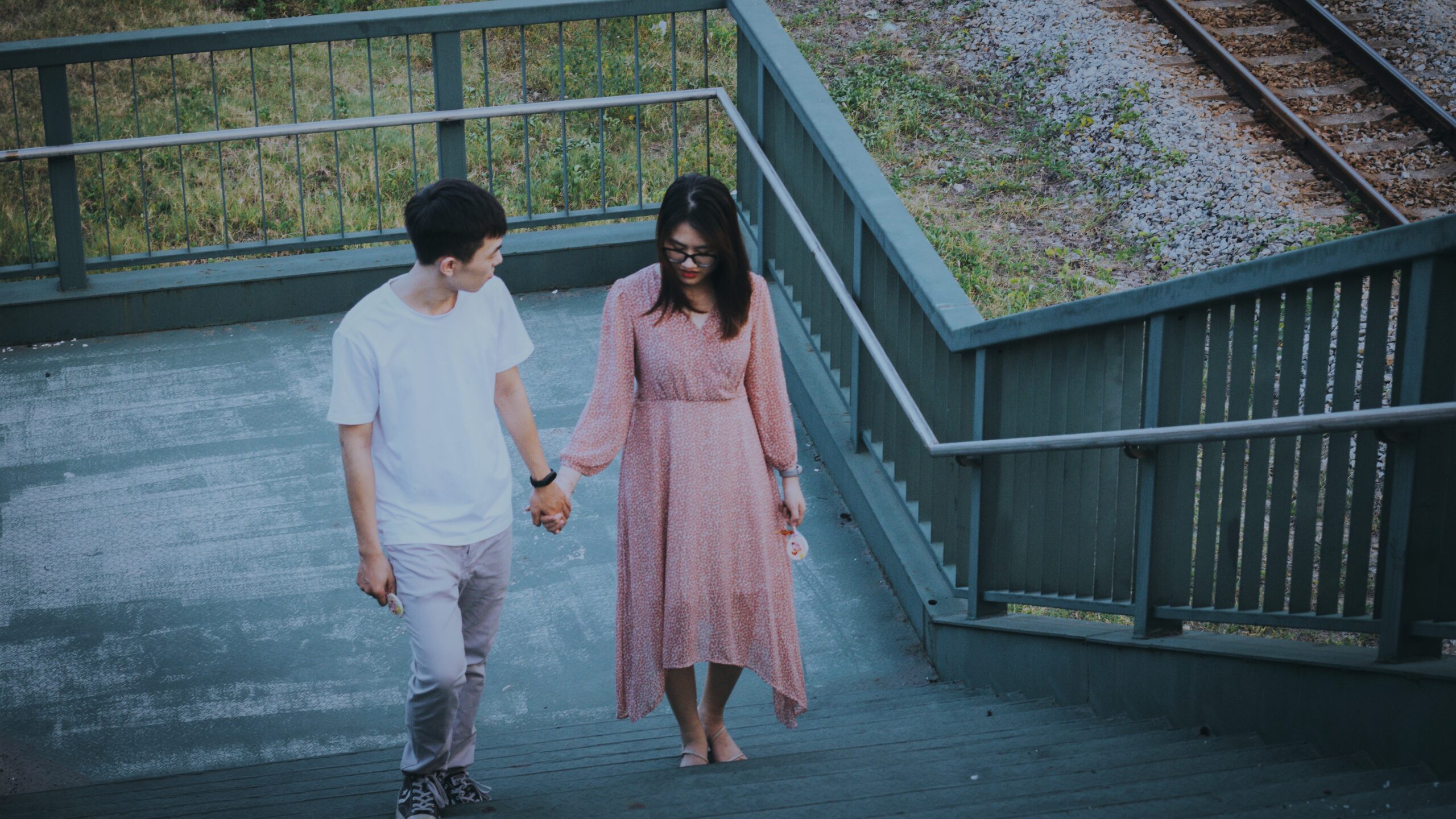 Couple walking up stairs while holding hands