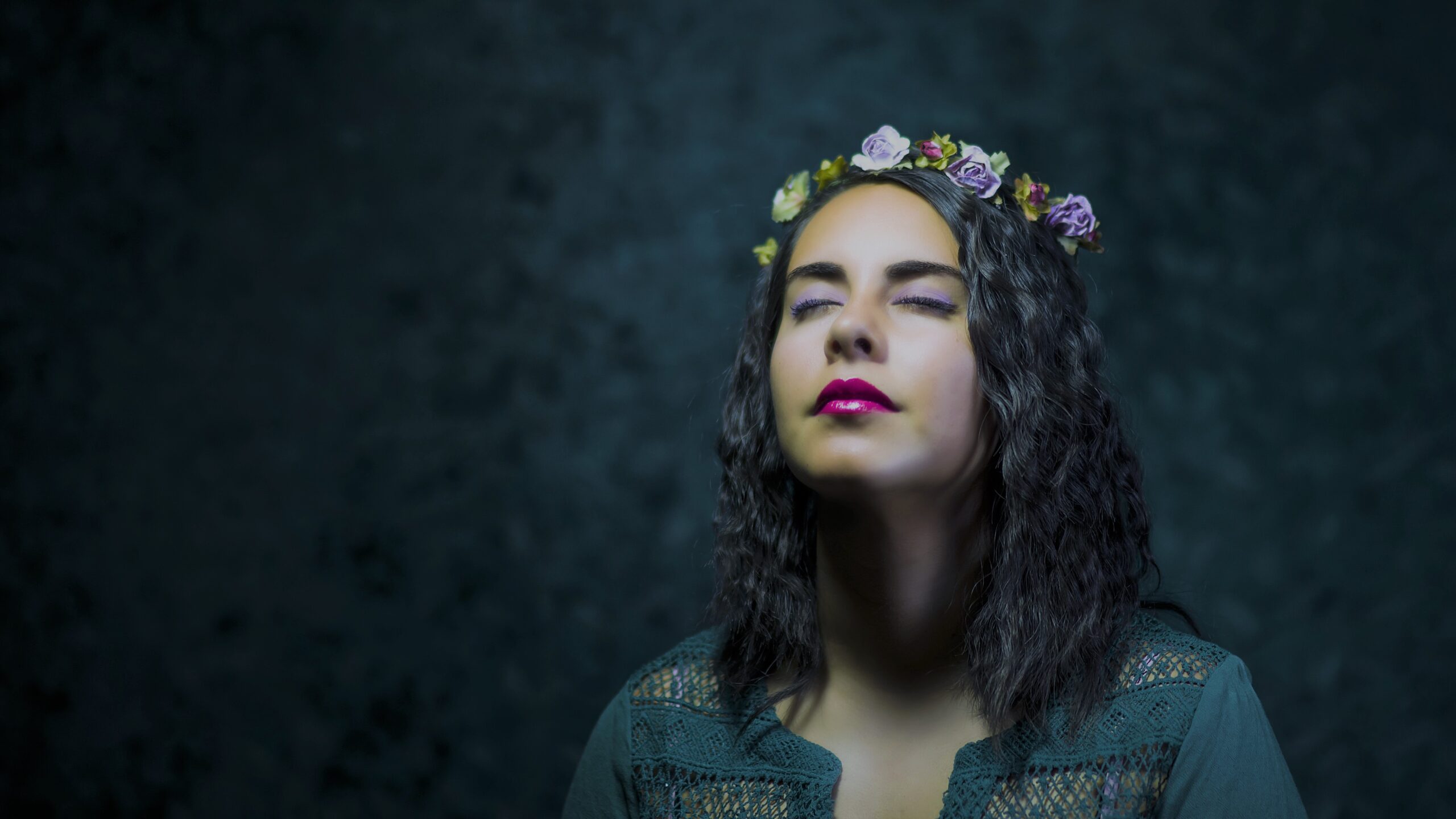 A woman with a flower headband meditates