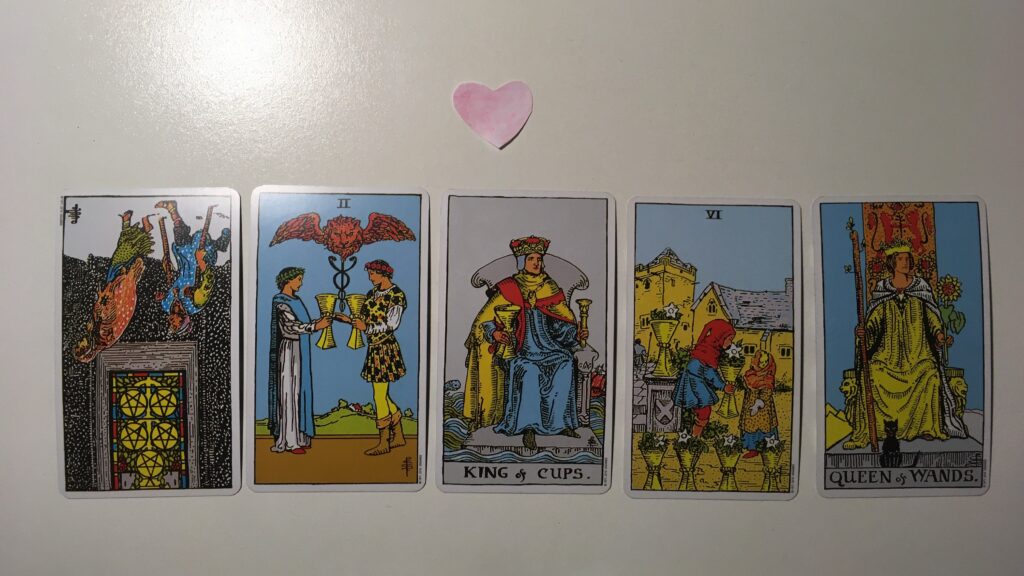 Five tarot cards with a heart above