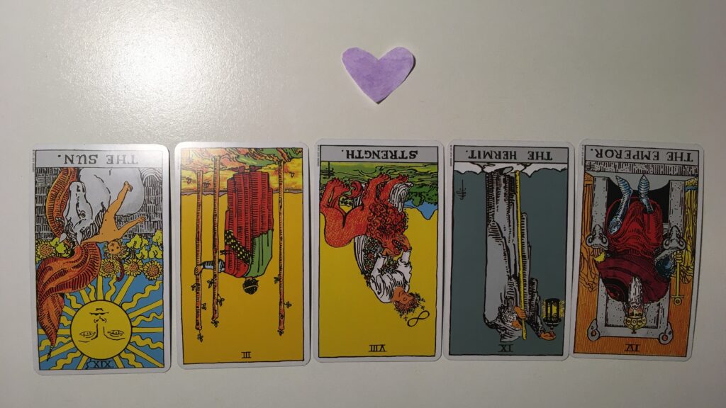 Five tarot cards with a heart above