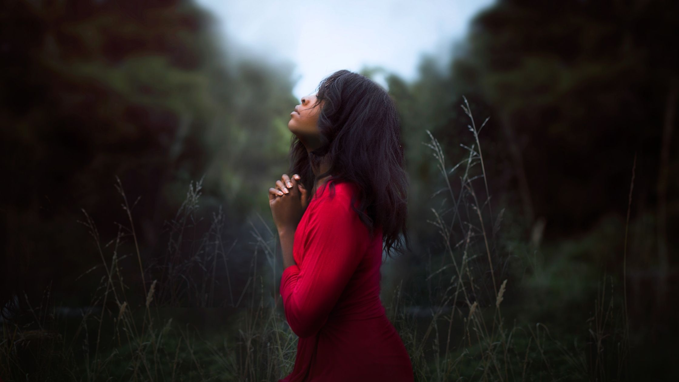 Woman praying outdoors