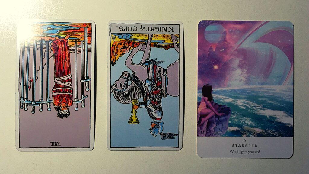 Two tarot cards and an oracle card