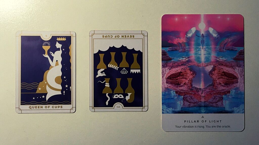 Two tarot cards and an oracle card