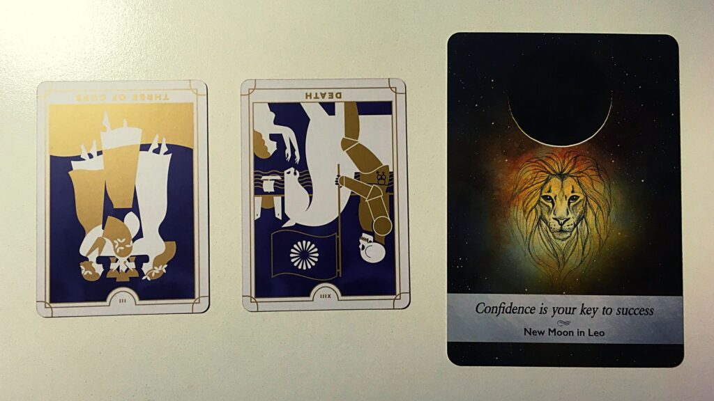 Two tarot cards and an oracle card