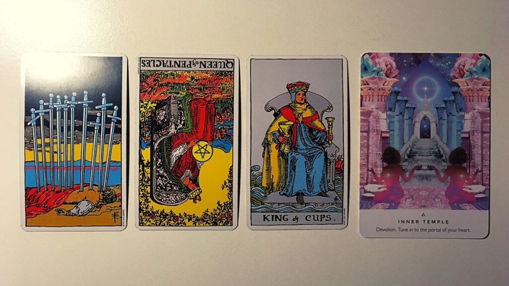 Three tarot cards and an oracle card