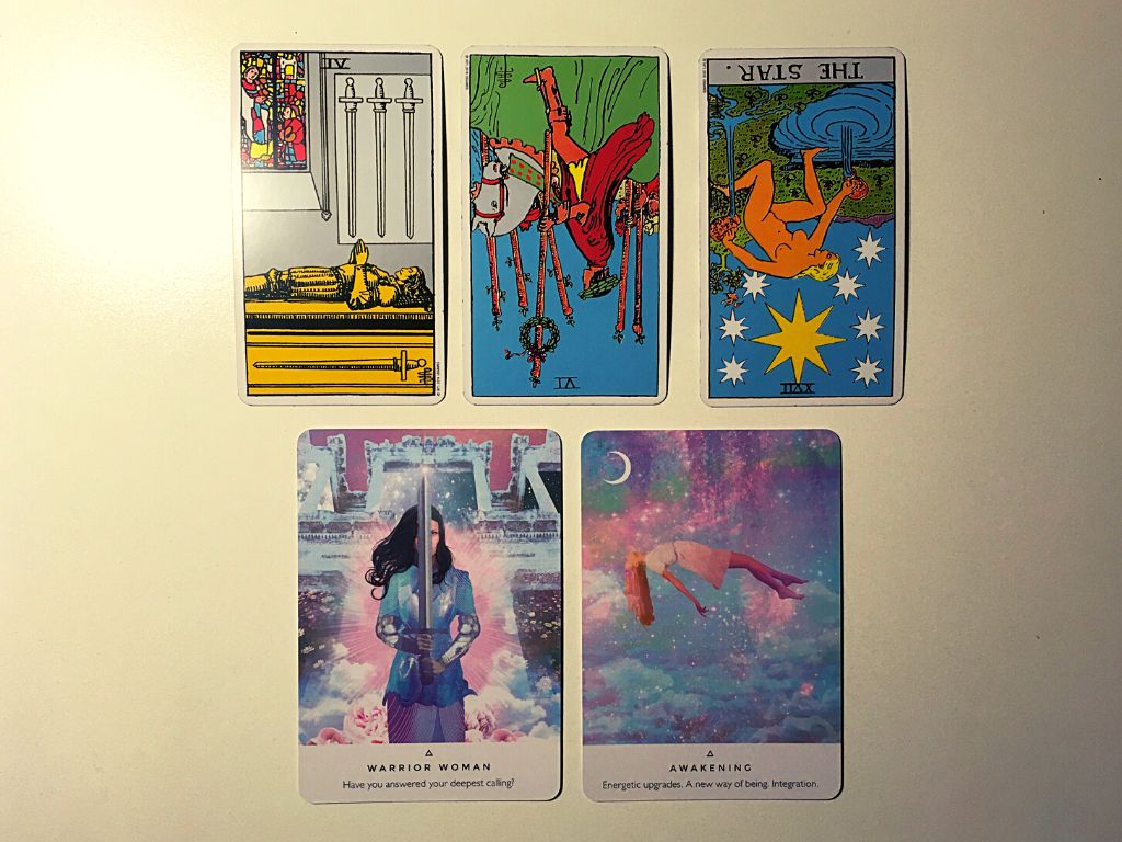 Three tarot cards and two oracle cards