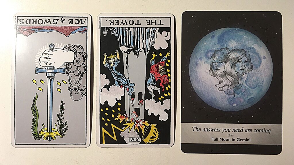 Two tarot cards and an oracle card