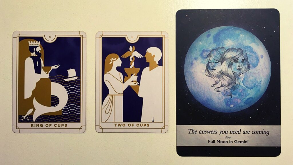 Two tarot cards and an oracle card