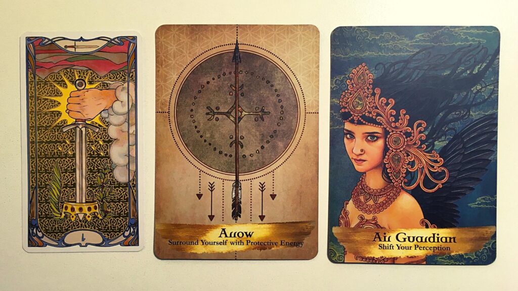 Ace of Swords Reversed from the Golden Art Nouveau Tart Deck; the Arrow and Air Guardian cards from the Angels and Ancestors Oracle Deck