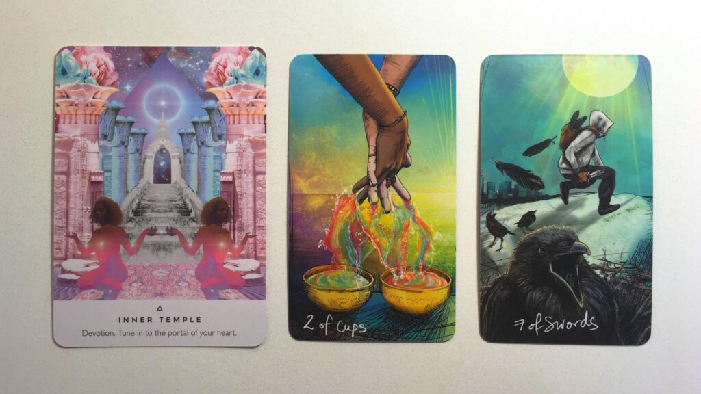 Imrama from the Work Your Light Oracle deck; the Two of Cups and the Seven of Swords cards from the Light Seer's Tarot