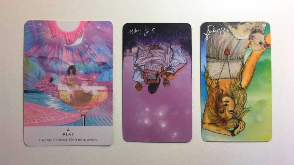 Play from the Work Your Light oracle deck; the Three of Cups, Reversed and the Strength, Reversed cards from the Light Seer's Tarot deck