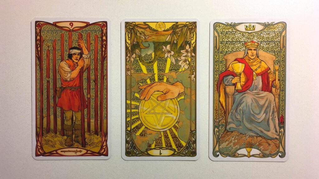 Nine of Wands, Ace of Pentacles, and King of Cups from the Golden Art Nouveau Tarot deck