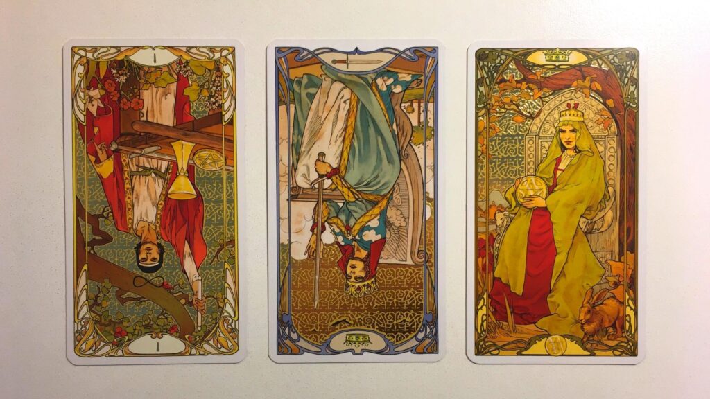 The Magician, the Queen of Swords, Reversed, and the Queen of Pentacles from the Golden Art Nouveau Tarot deck