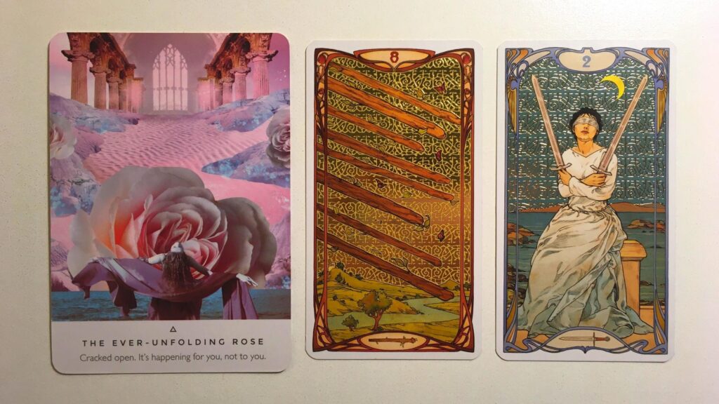 The Ever-Unfolding Rose from the Work Your Light Oracle deck; the Eight of Wands and the Two of Swords from the Golden Art Nouveau Tarot deck