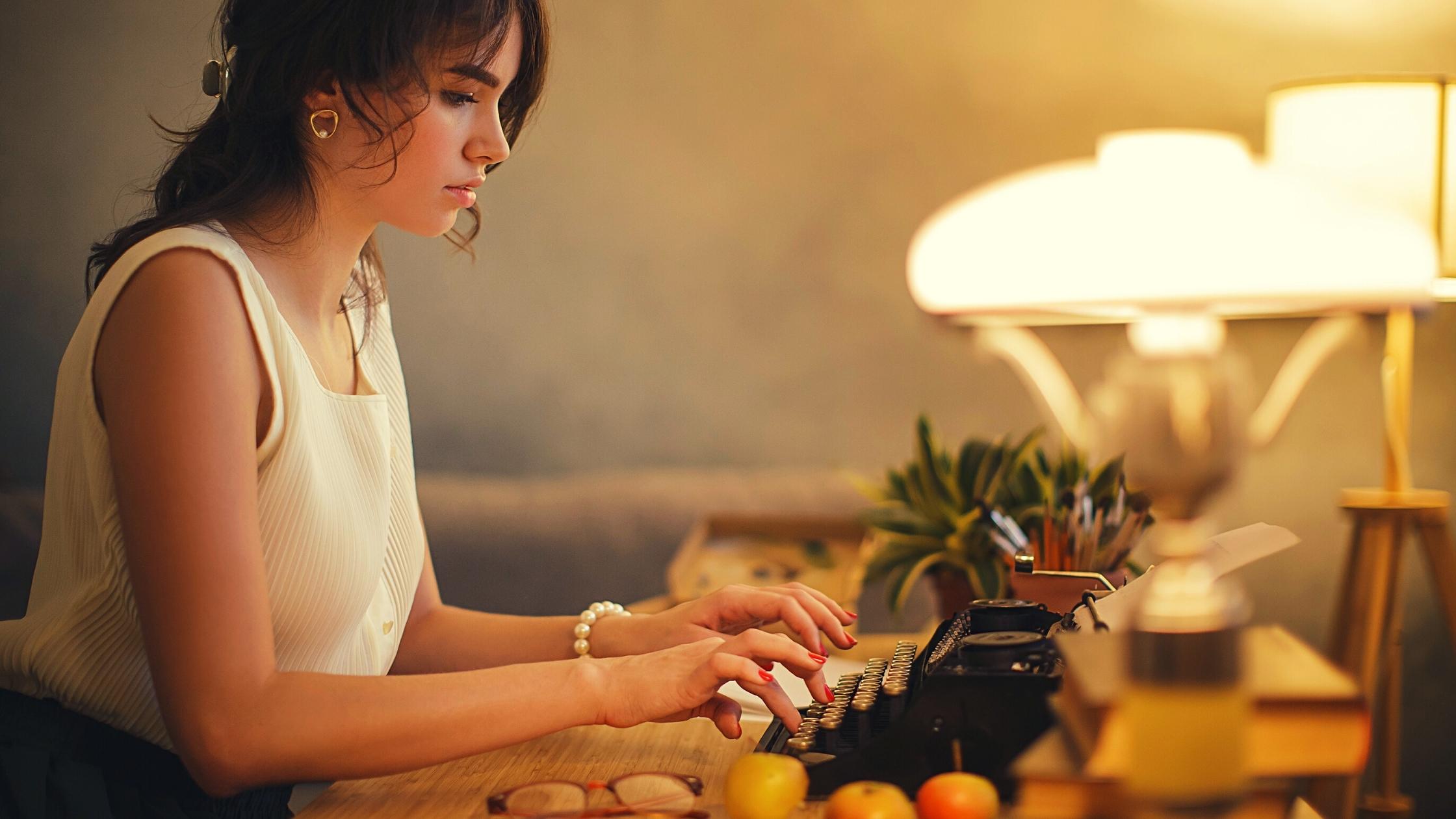 Woman writing on a typewriter