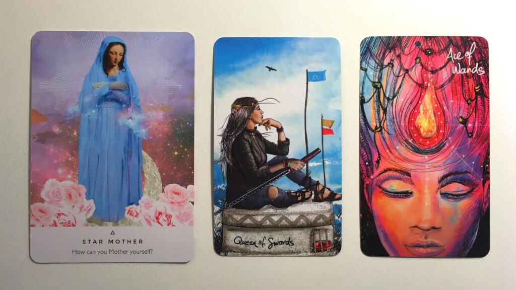 Star Mother from the Work Your Light Oracle deck; the Queen of Swords and the Ace of Wands from the Light Seer's Tarot deck