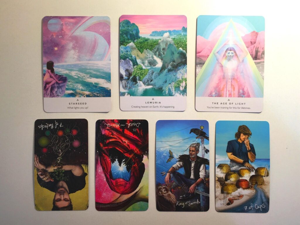 Three oracle cards from the Work Your Light oracle deck and four tarot cards from the Light Seer's Tarot deck