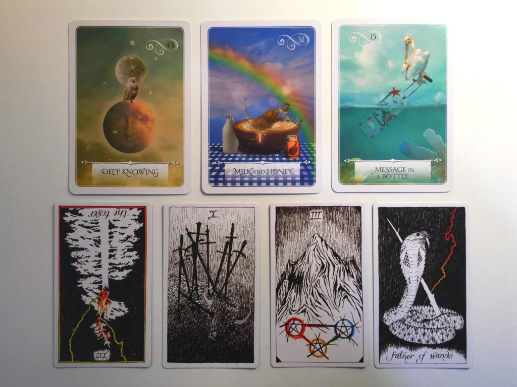 Three cards from the Wisdom of the Oracle deck and four cards from the Wild Unknown Tarot deck