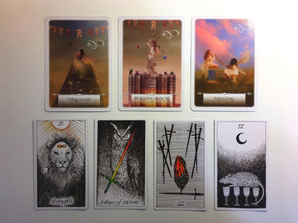 Three cards from the Wisdom of the Oracle and four cards from the Wild Unknown Tarot deck