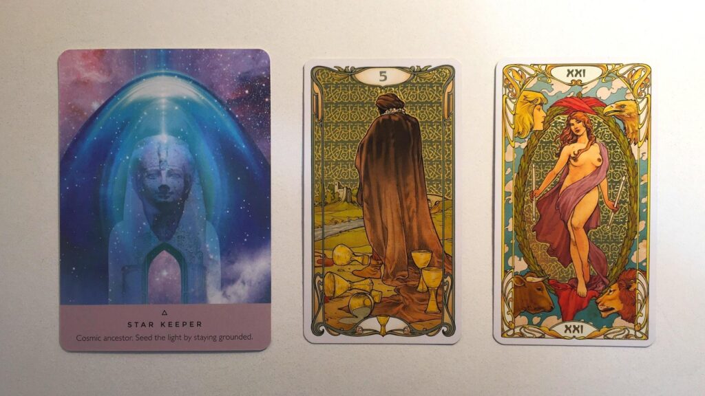 Card from the Starseed Oracle and two cards from the Golden Art Nouveau Tarot decks