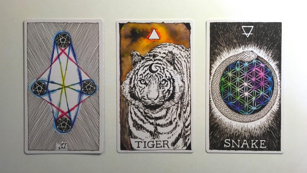 Card from the Wild Unknown Tarot and two cards from the Animal Spirit Oracle decks