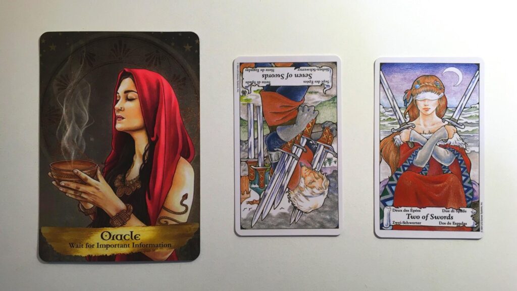 Card from the Angel and Ancestors Oracle and two cards from the Hanson-Roberts Tarot decks