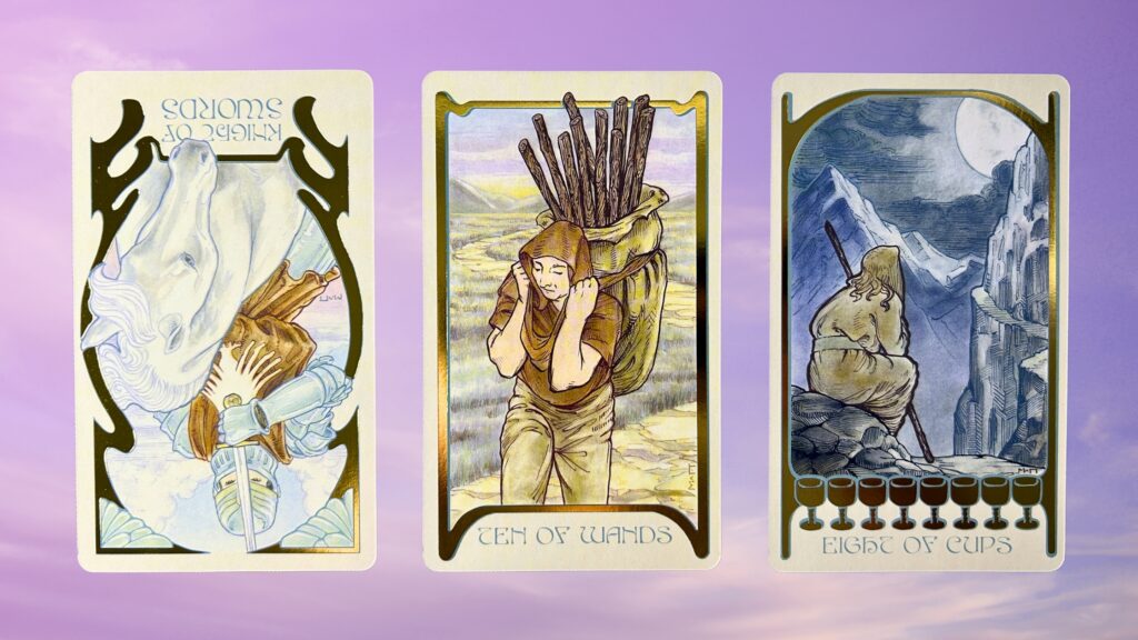 Cards from the Ethereal Visions Illuminated Tarot deck: Knight of Swords, Ten of Wands, and Eight of Cups