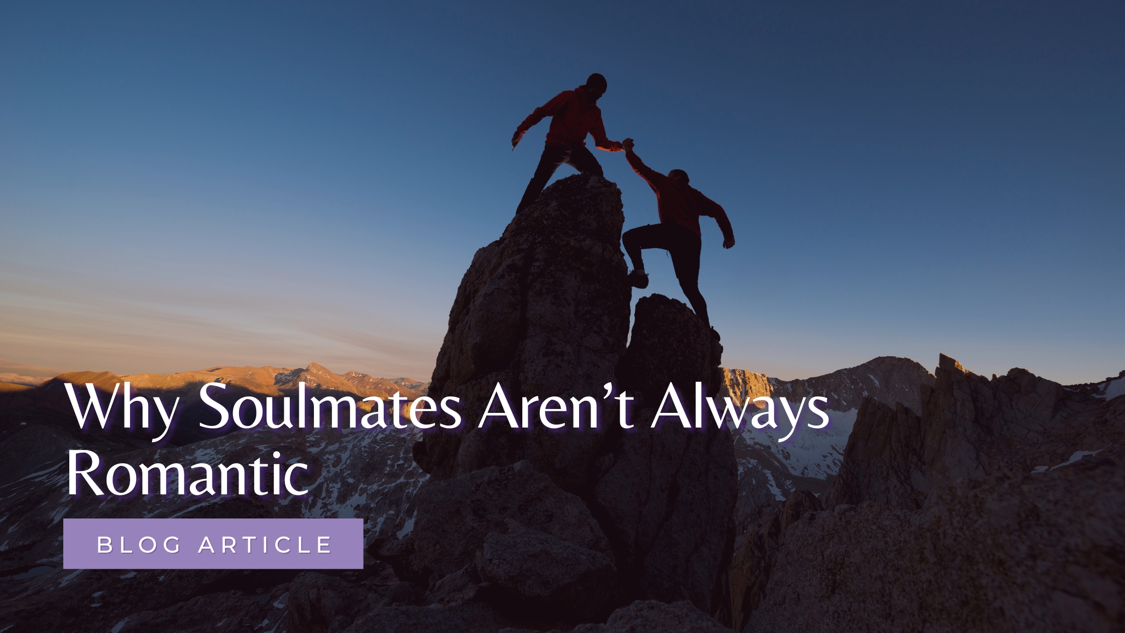 A mountain climber helping another up the summit