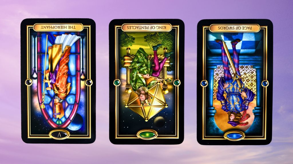 Cards from the Gilded Tarot: The Hierophant, King of Pentacles, and Page of Swords