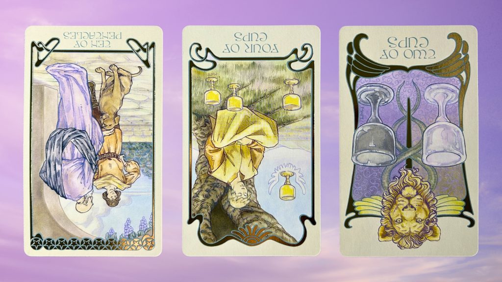 Cards from the Ethereal Visions Illuminated Tarot deck: ten of pentacles, four of cups, and two of cups