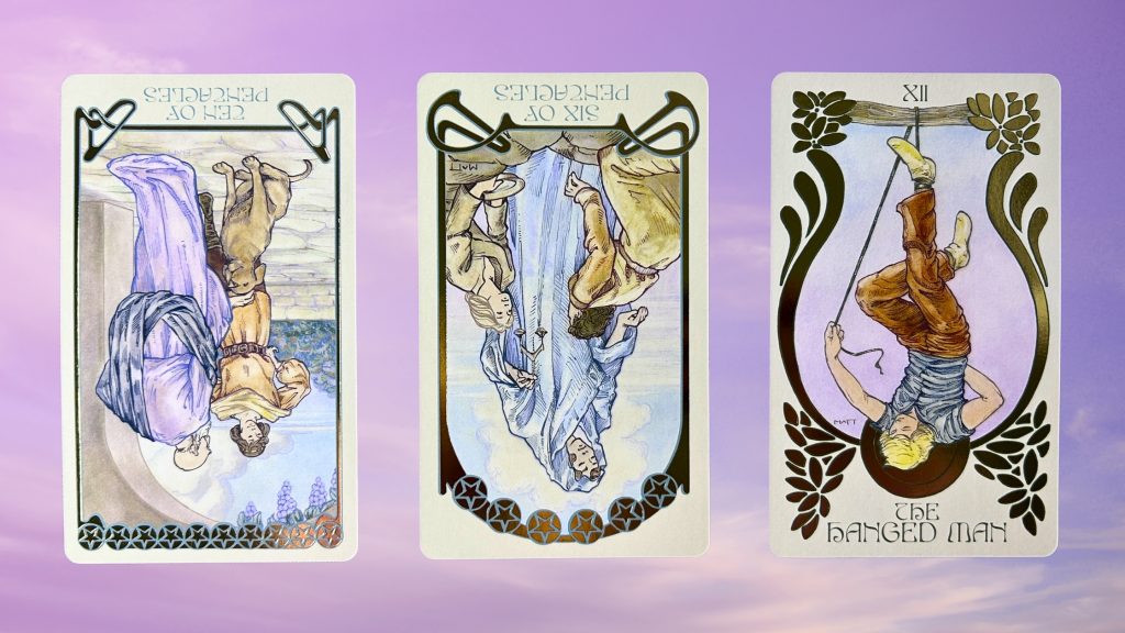 Cards from the Ethereal Visions Illuminated Tarot deck: ten of pentacles, six of pentacles, and the hanged man