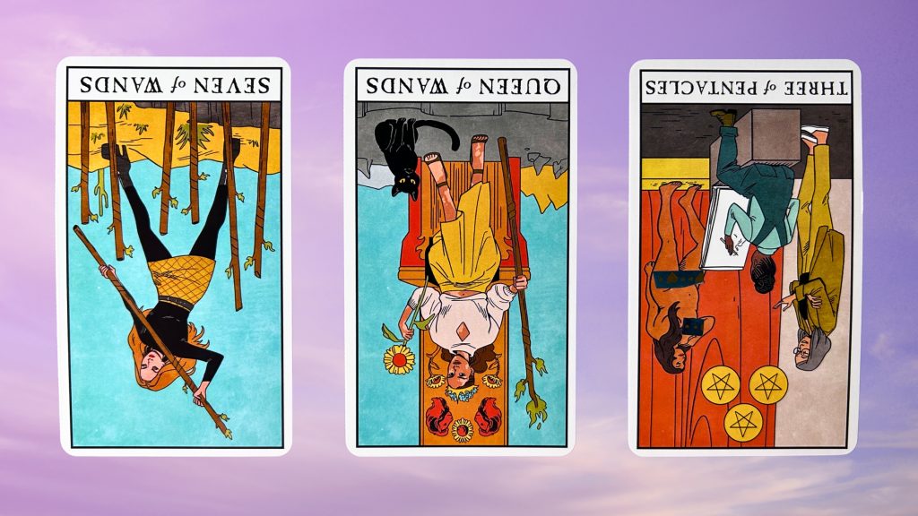 Cards from the Modern Witch Tarot deck: seven of wands, the queen of wands, and the three of pentacles